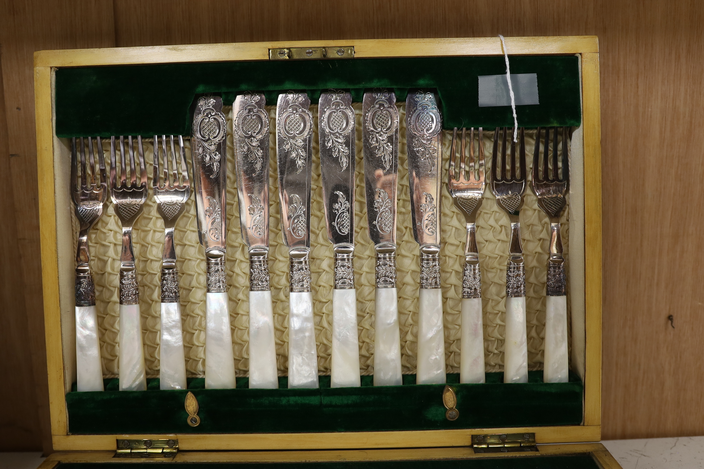 A cased set of twelve mother-of-pearl handled fish knives and forks